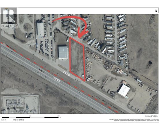A satellite image of a property with a red outline and a dashed line running through it.