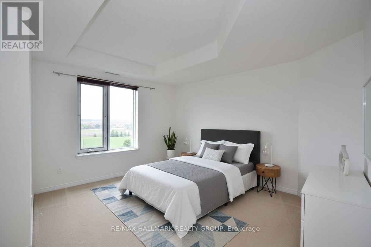 A bedroom with a large bed and a window overlooking a green landscape.
