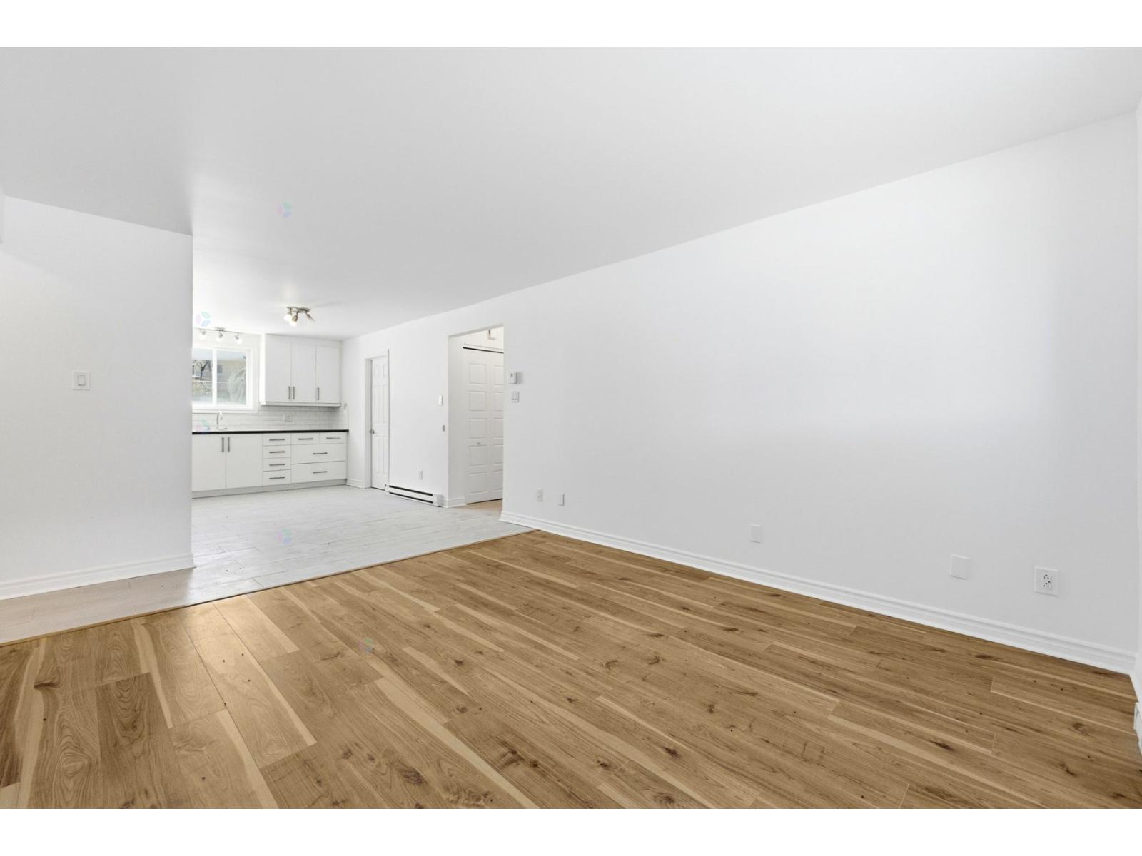 A room with wooden floors and white walls.