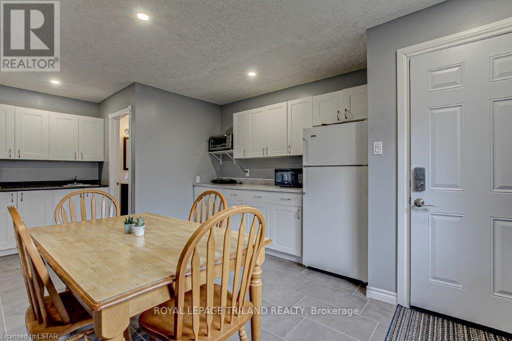 A kitchen with a table and chairs in the foreground.