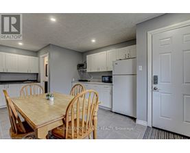 A kitchen with a table and chairs in the foreground.