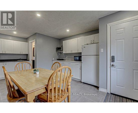 A kitchen with a table and chairs in the foreground.