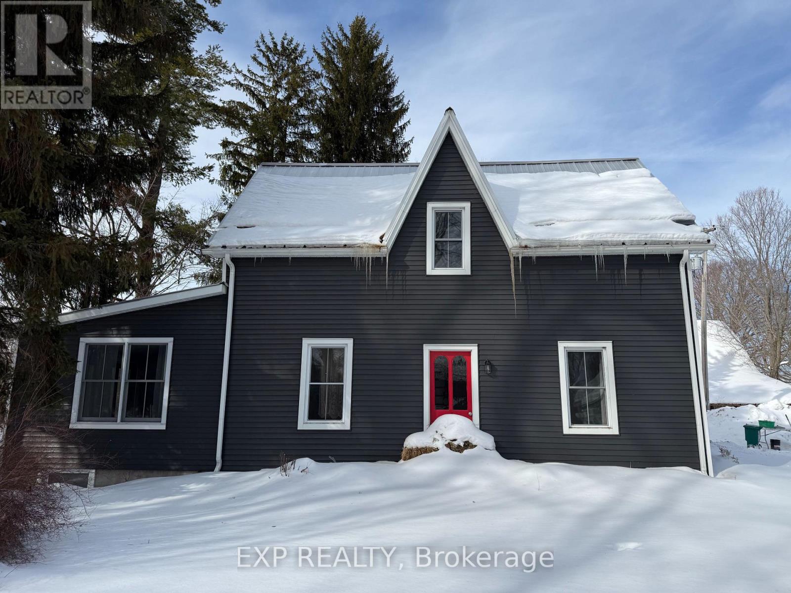 A house with a red door is for sale in Brokerage.