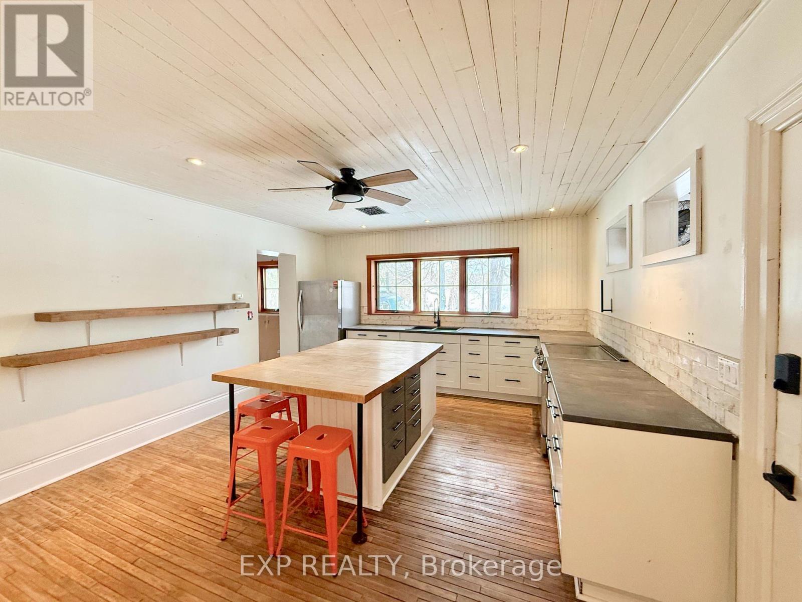 A kitchen with a table and chairs in the middle of the room.