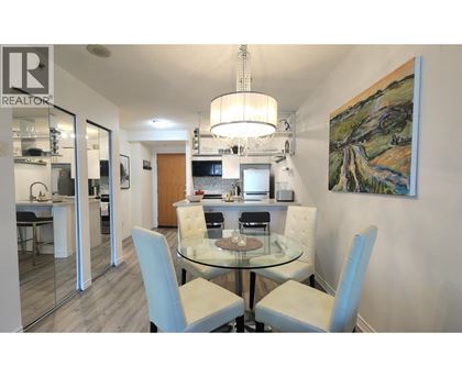 A dining room with a glass table and chairs.