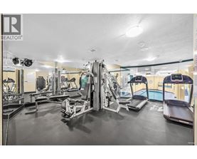 A gym with a variety of equipment including treadmills, weights, and exercise machines.