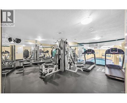 A gym with a variety of equipment including treadmills, weights, and exercise machines.
