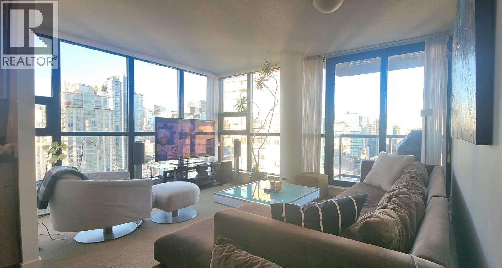 A living room with a couch, chairs, and a coffee table.