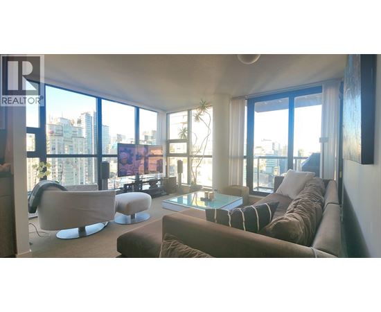 A living room with a couch, chairs, and a coffee table.