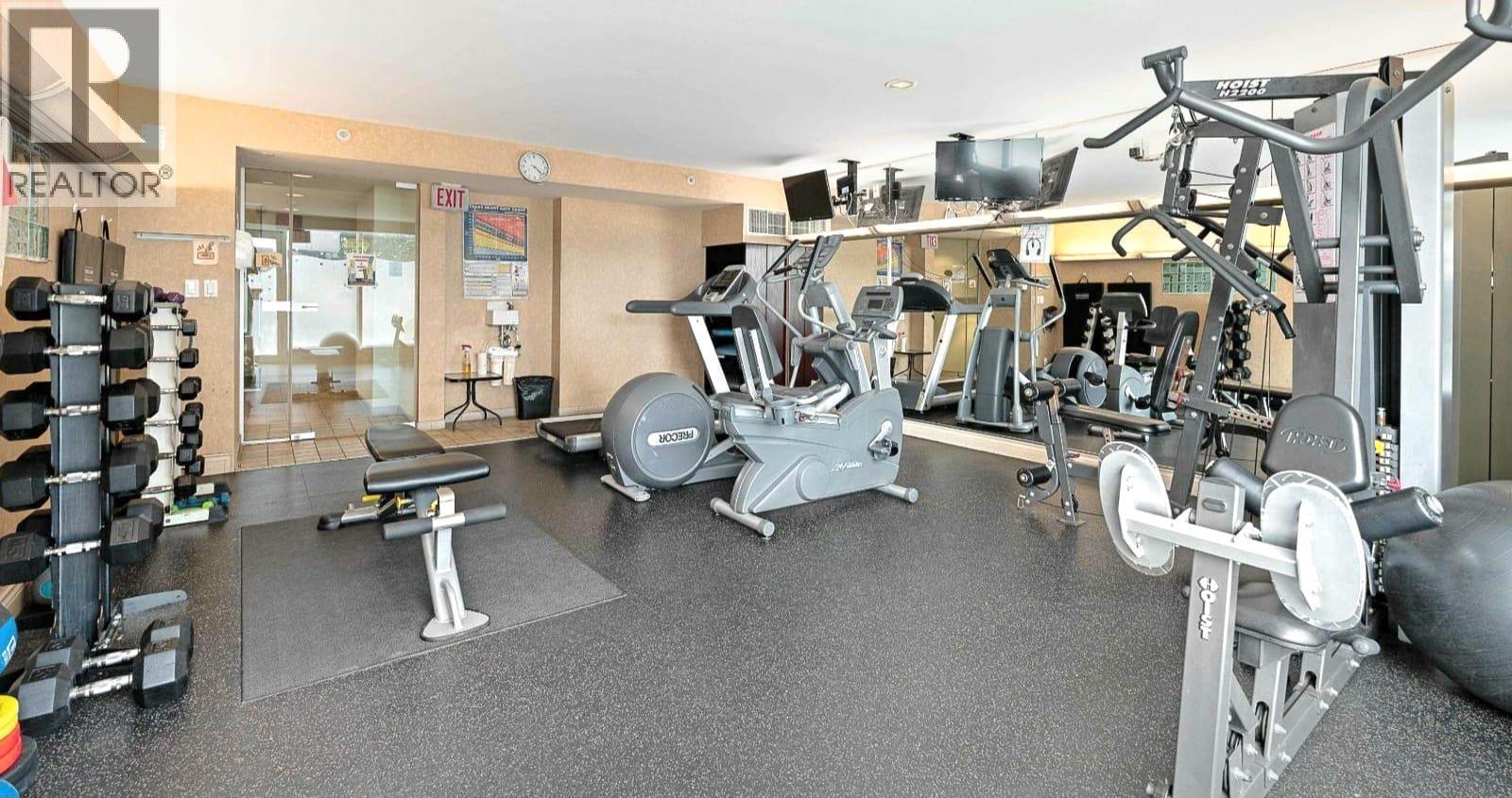 A gym with a variety of equipment including weights and machines.