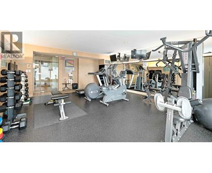 A gym with a variety of equipment including weights and machines.