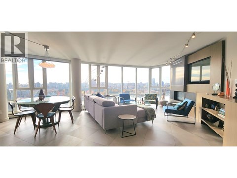 A living room with a dining table and a couch.