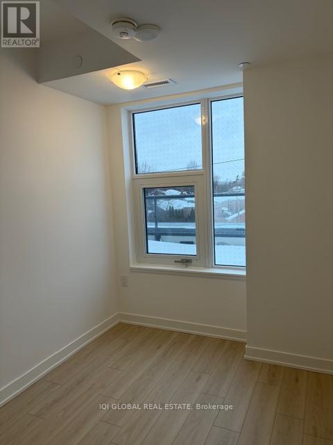 A room with a window and a view of a snowy landscape outside.