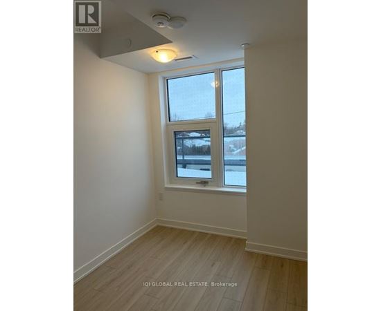 A room with a window and a view of a snowy landscape outside.