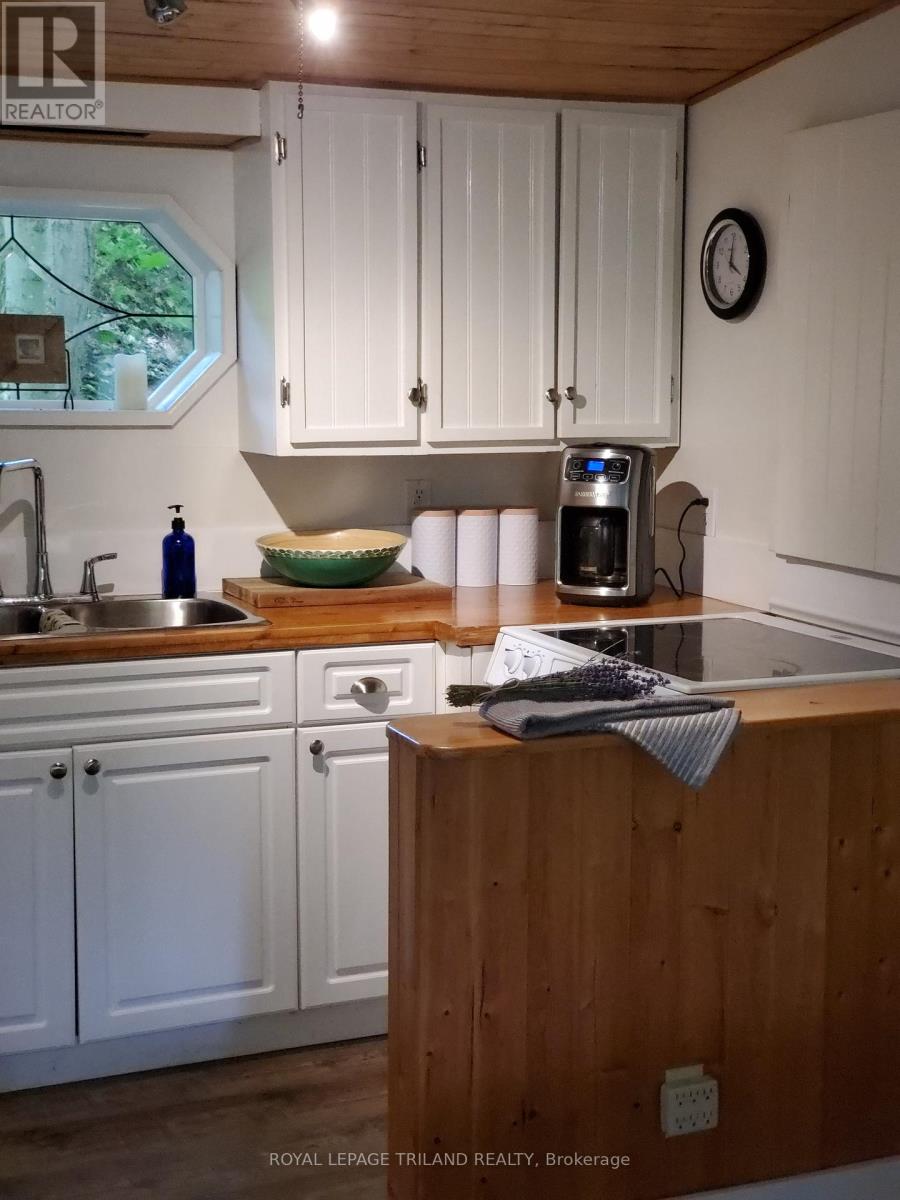 A kitchen with wooden cabinets and a wooden counter top.