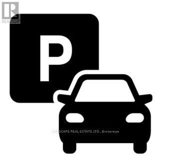 A black and white image of a car and a parking sign.