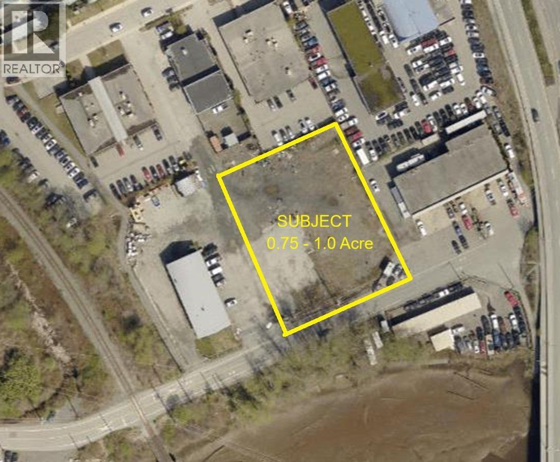 An aerial image of a parking lot with a yellow box around a specific area.