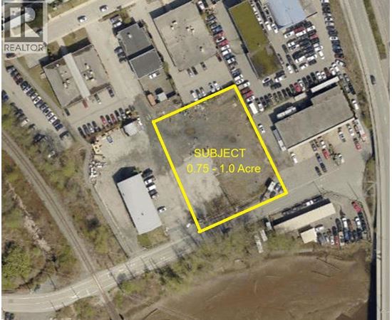 An aerial image of a parking lot with a yellow box around a specific area.