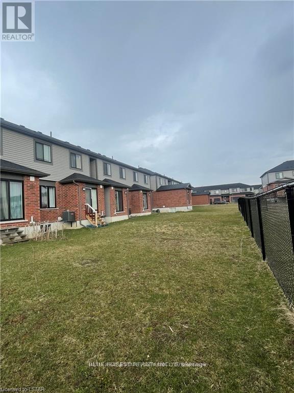 A row of houses with a grassy area in front.