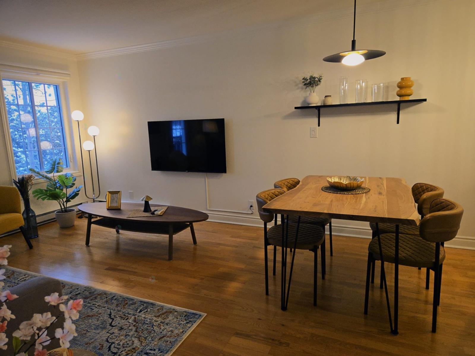 A living room with a wooden table and chairs.