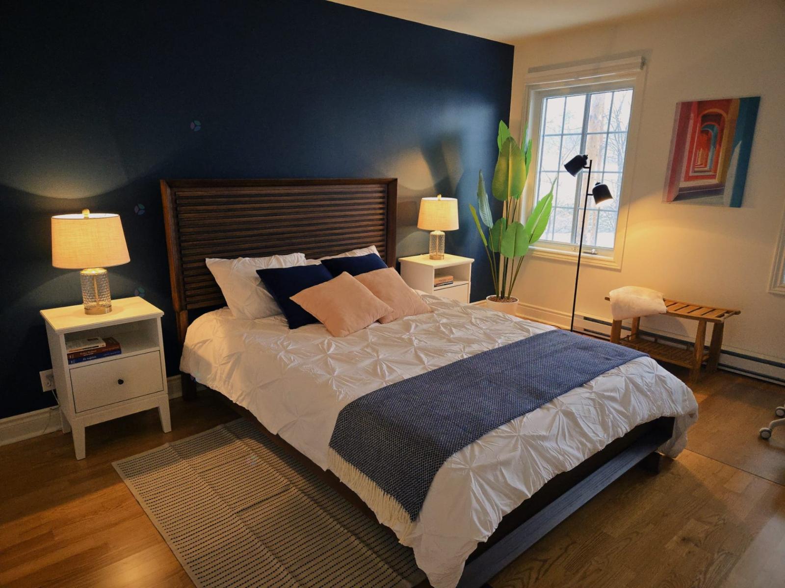 A bedroom with a large bed and a window.