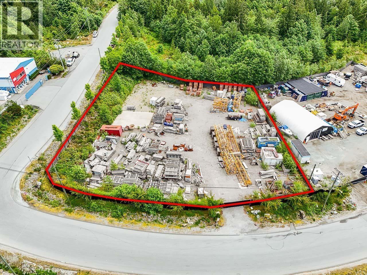 An aerial view of a construction site surrounded by a red boundary.