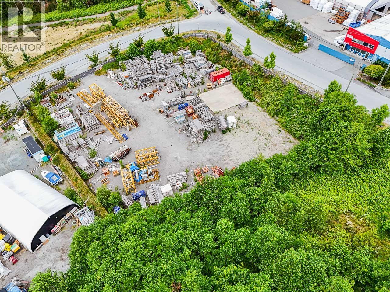 A construction site surrounded by trees and buildings.