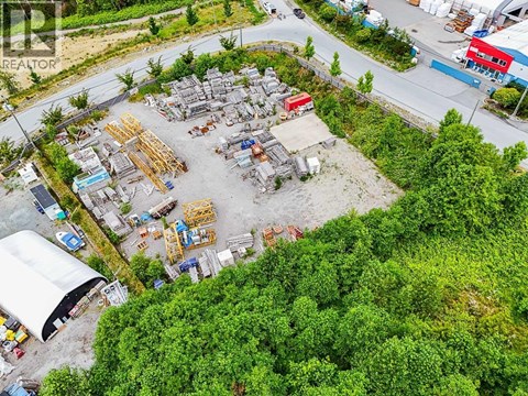 A construction site surrounded by trees and buildings.
