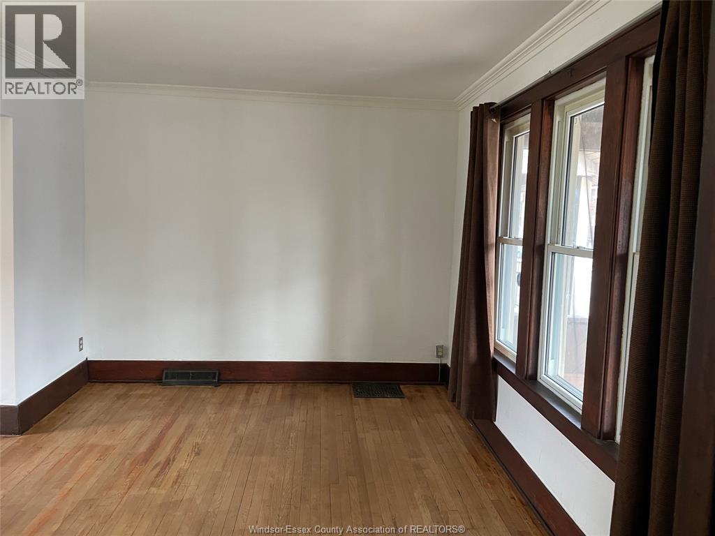 A room with wooden floors and white walls.