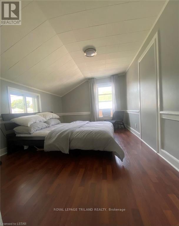 A bedroom with a bed and a window.