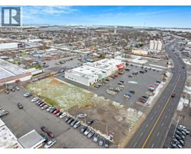 A parking lot with cars and a road running through it.