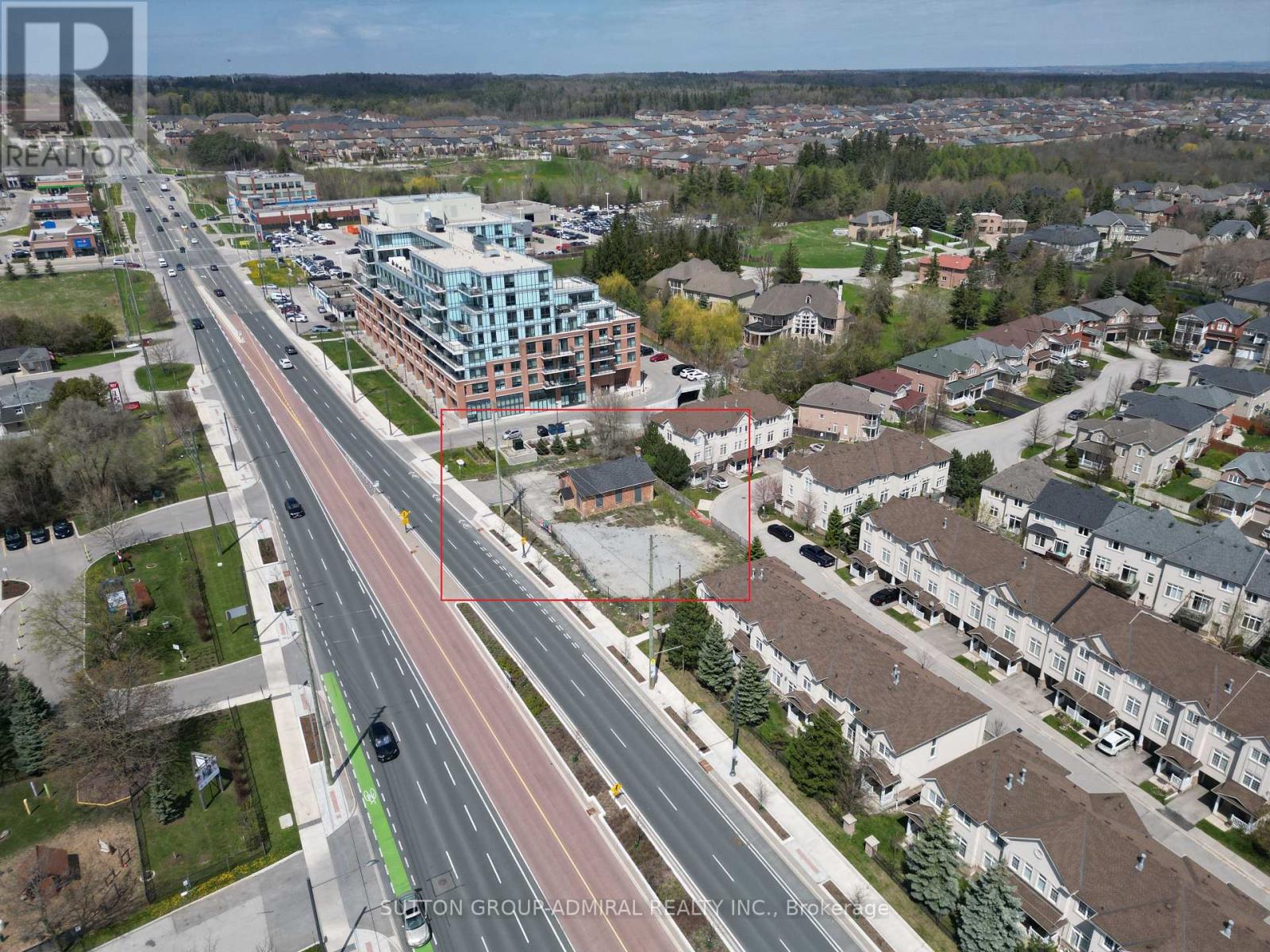 A bird's eye view of a city with a road running through the middle of it.