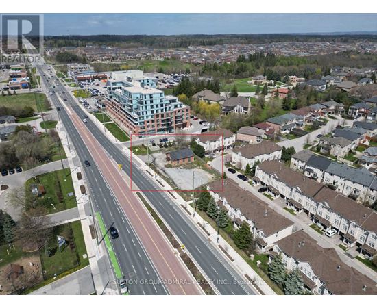 A bird's eye view of a city with a road running through the middle of it.