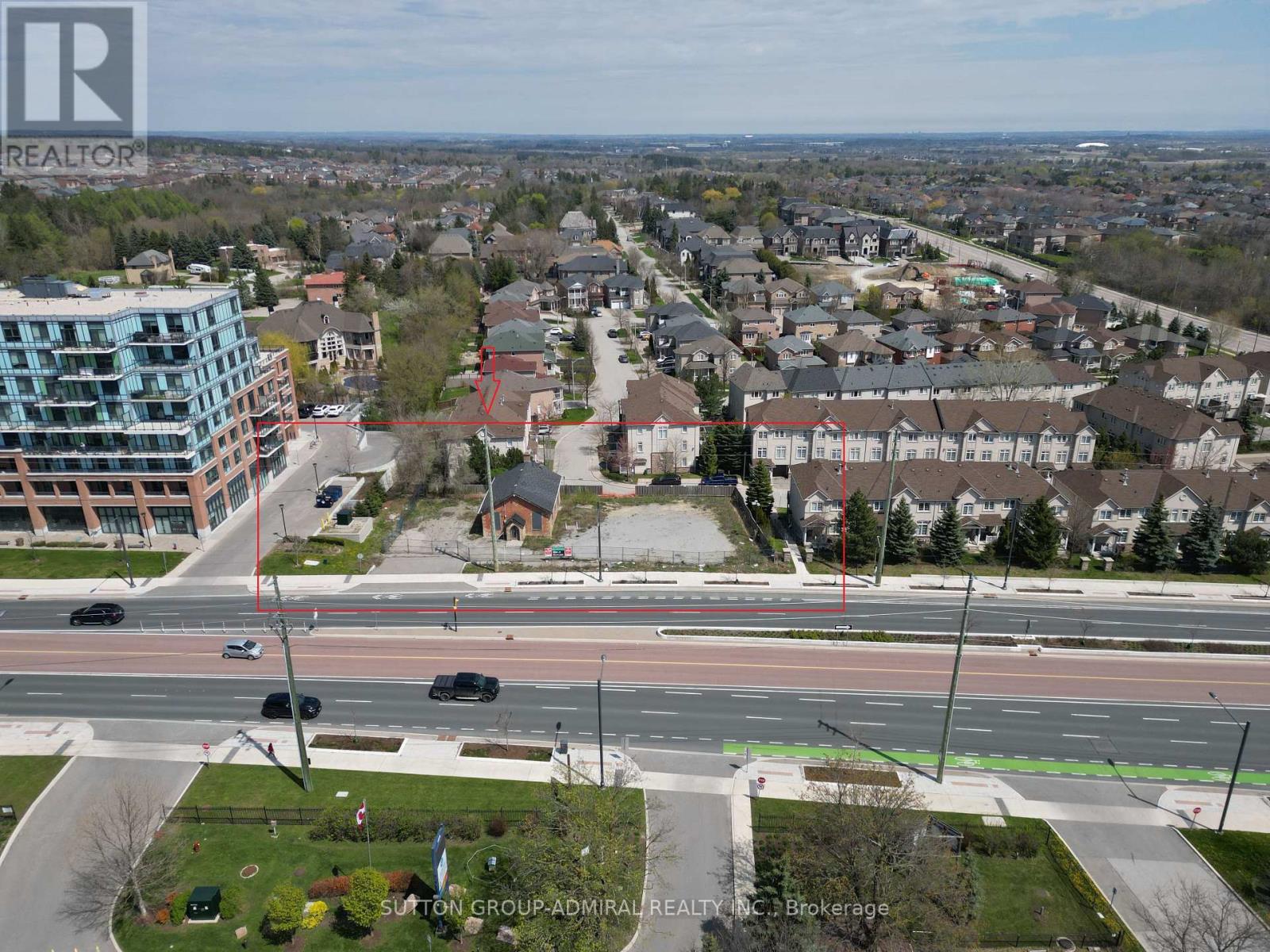 A real estate company logo is superimposed on a picture of a suburban street.