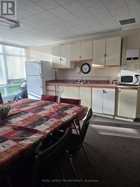 A kitchen with a table and chairs in front of it.