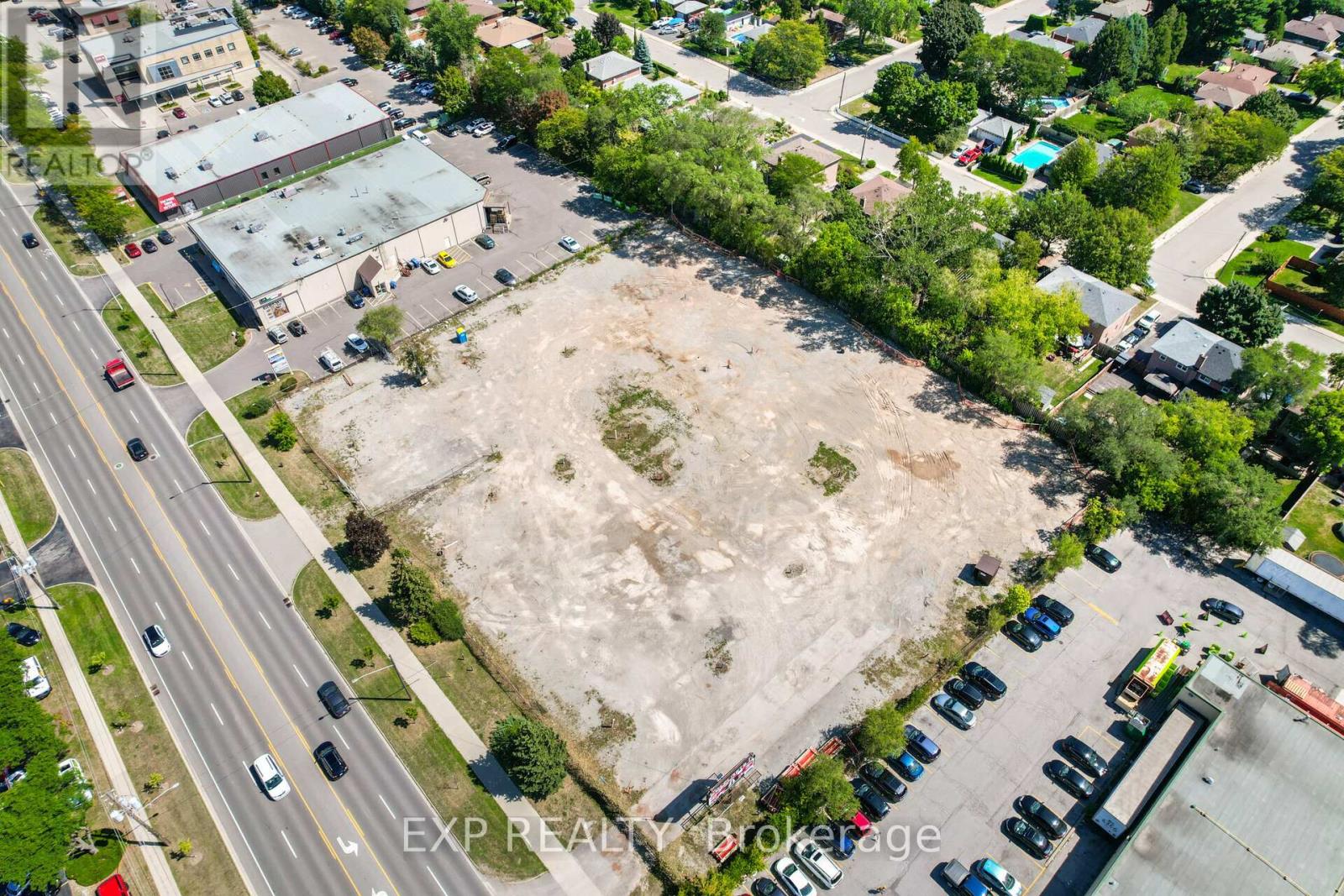 An aerial view of a parking lot and a road with cars.