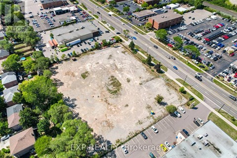 An aerial view of a parking lot with a large empty space in the middle.