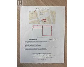 A piece of paper with a map and details of a development site for sale.