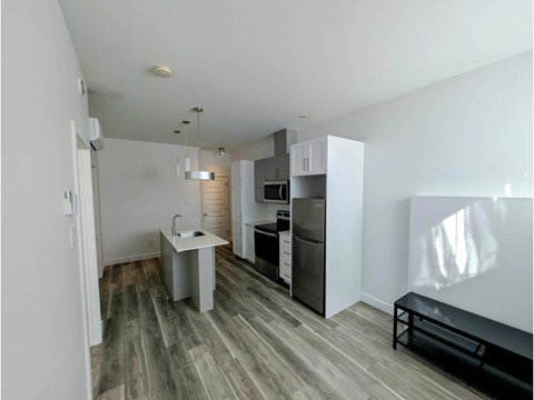 A kitchen with a sink and a refrigerator.