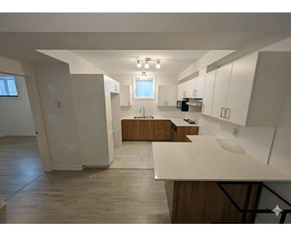 A kitchen with wooden cabinets and a white countertop.