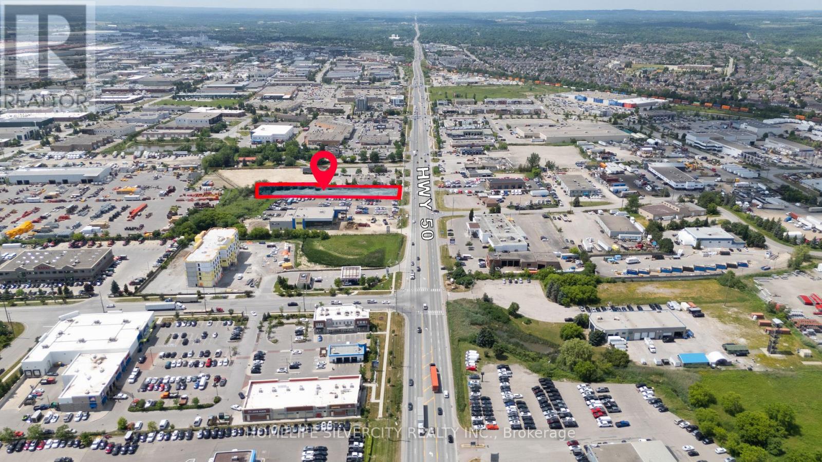 A red area is marked on a highway in the middle of a city.