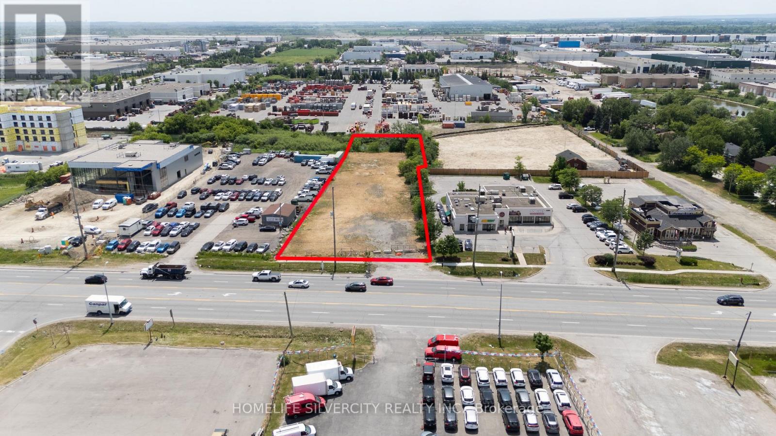 An aerial view of a parking lot with a red outline indicating a specific area.