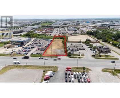 An aerial view of a parking lot with a red outline indicating a specific area.