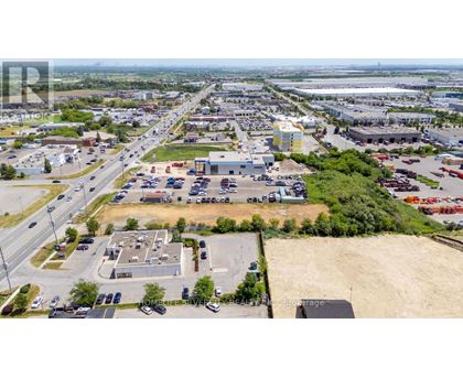 A large industrial area with a parking lot and buildings.