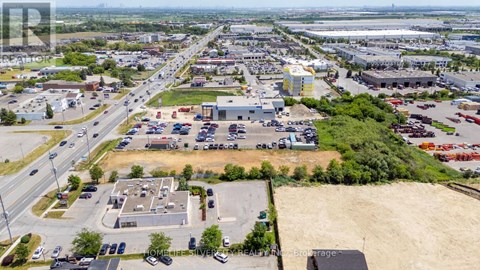 A large industrial area with a parking lot and buildings.