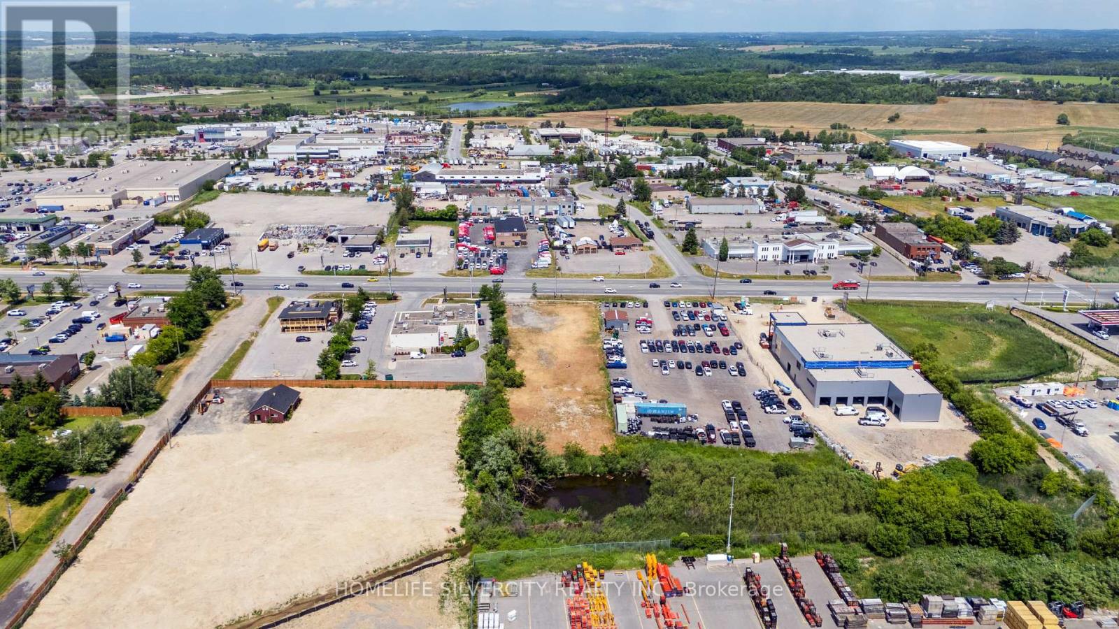 An aerial view of a large industrial area with multiple buildings and vehicles.