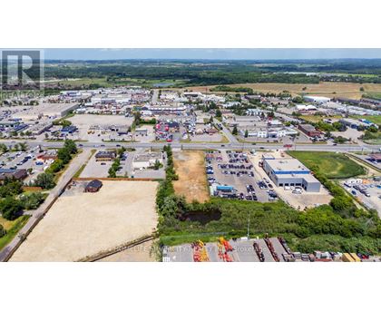 An aerial view of a large industrial area with multiple buildings and vehicles.