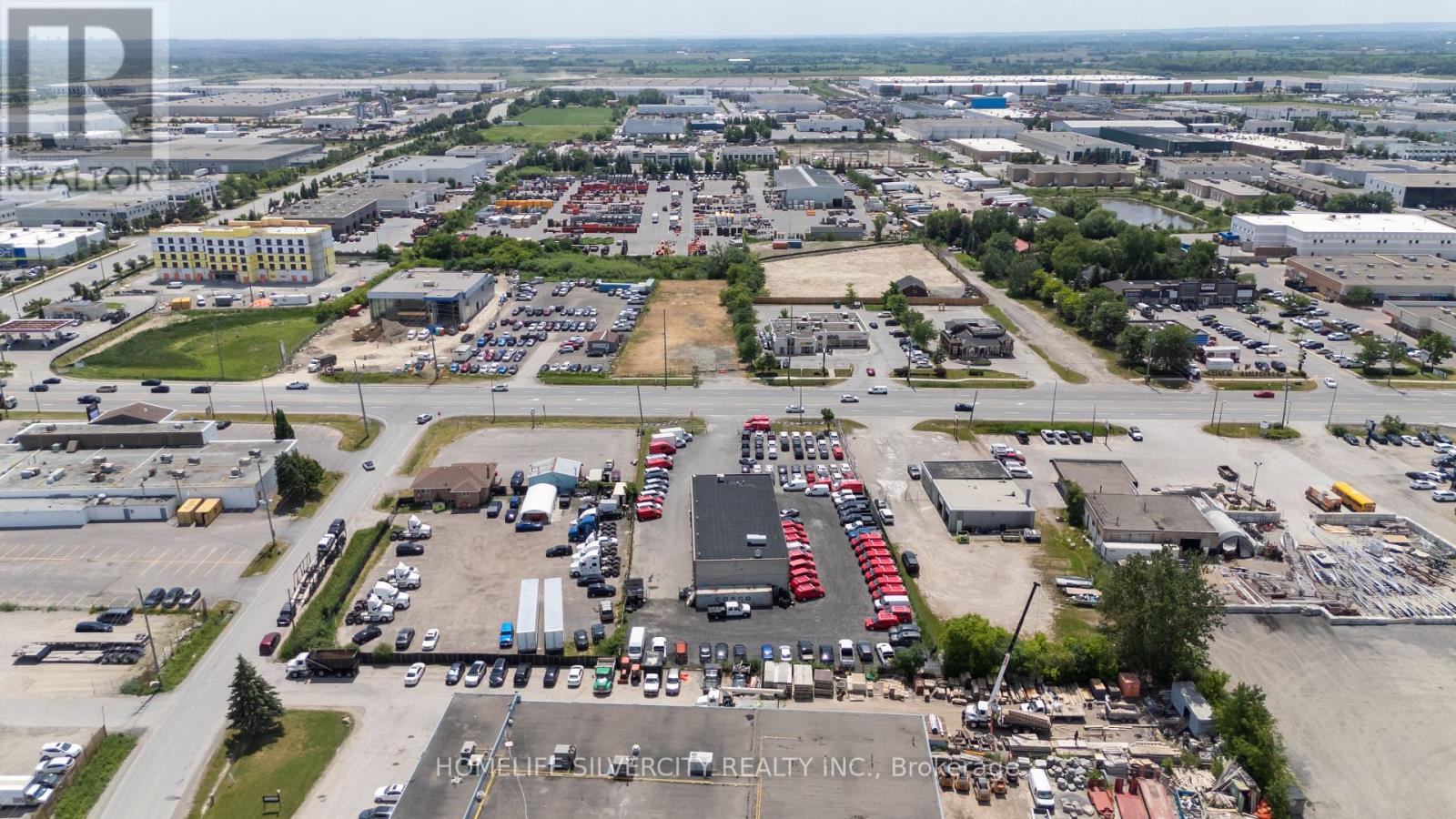 A large industrial area with a variety of buildings and vehicles.