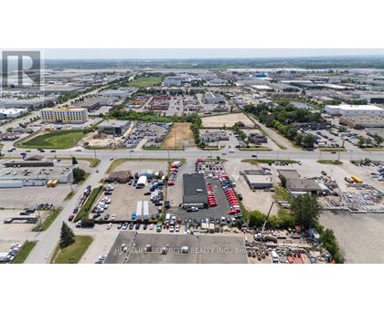A large industrial area with a variety of buildings and vehicles.