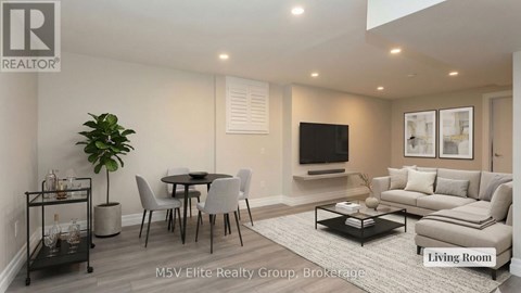 A living room with a dining table and chairs.